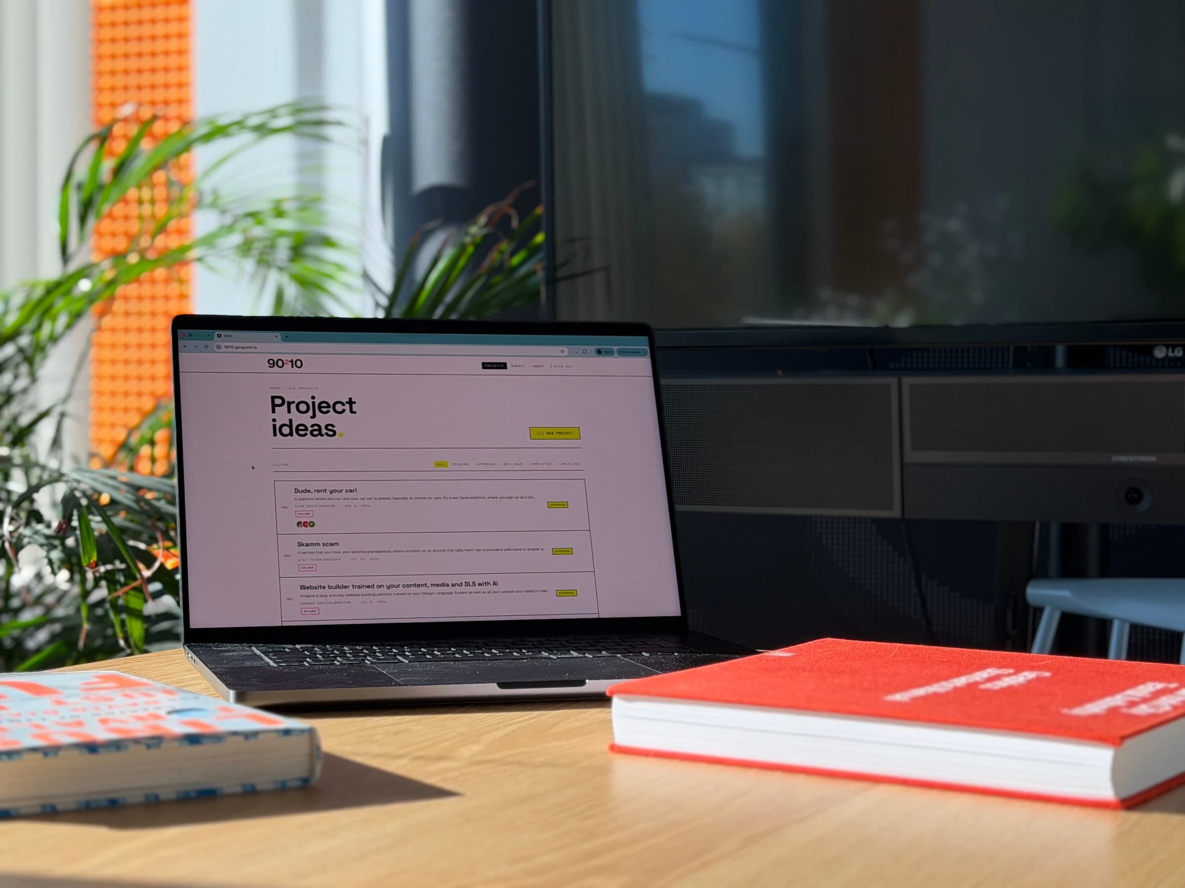 The 90210 project ideas page open on a laptop, listing submitted ideas with their author, date and status, and a button for adding a new project